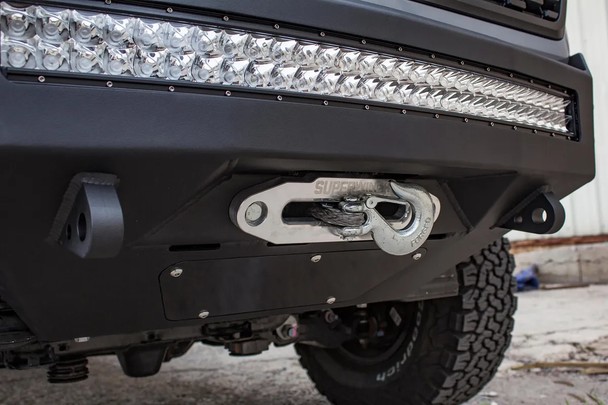 HoneyBadger front bumper with winch mount and 30 Universal LED bar mounts with HB logo cutout with 10 SR Rigid bar mounts in side panels in Hammer Black with Satin Black panels product image