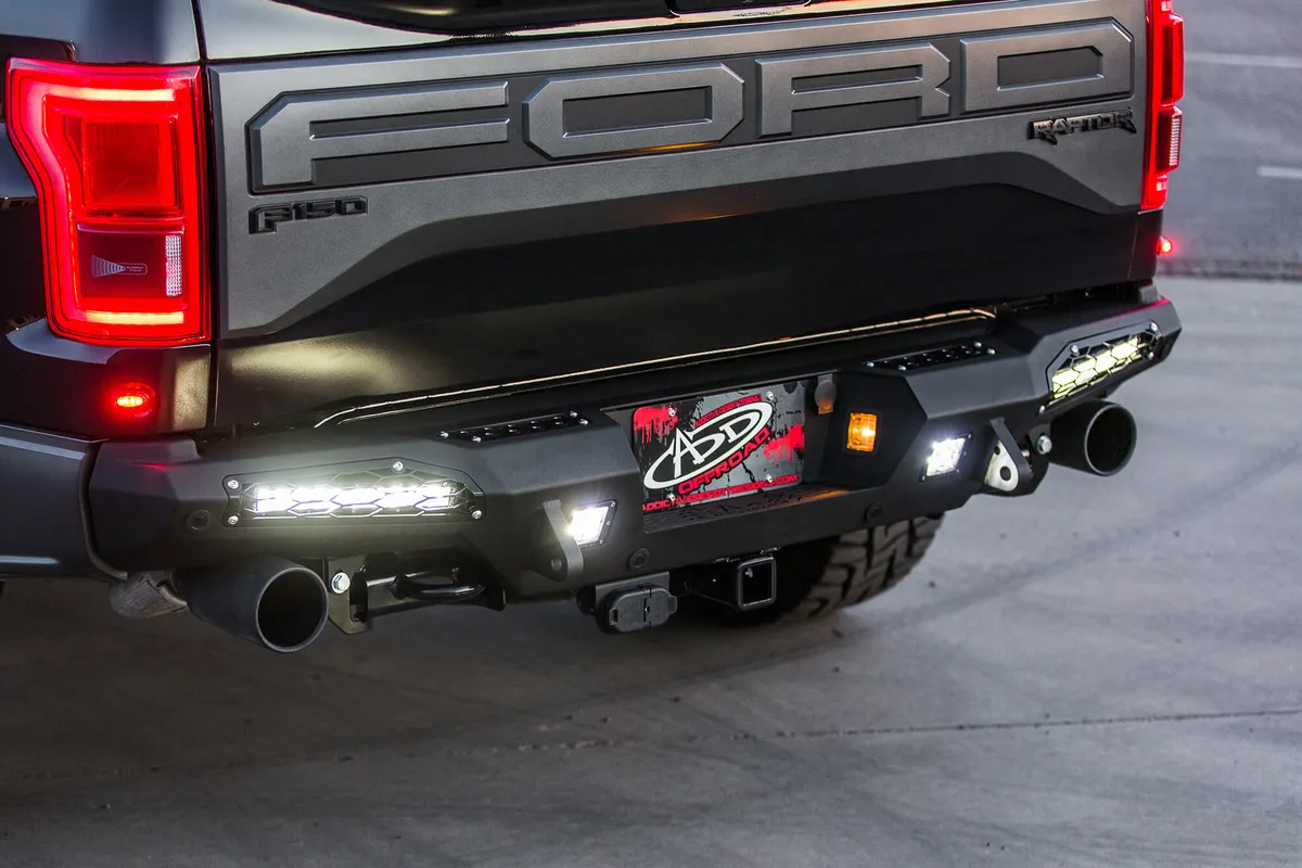 2017 Ford Raptor Honeybadger Rear Bumper With Tow Hooks And Backup Sensors With 10 sr LED Light Bar Mounts And Dually Mounts in Hammer Black With Satin Black Panels. product image