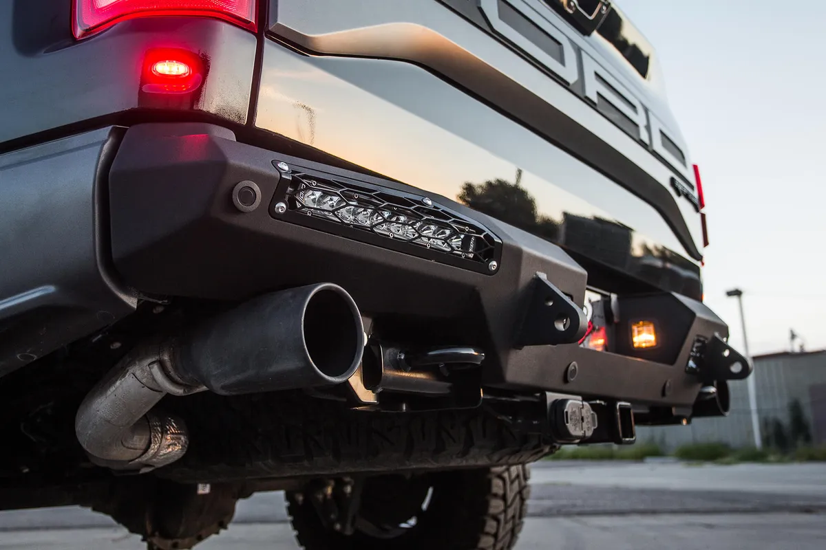 2017 Ford Raptor Honeybadger Rear Bumper With Tow Hooks And Backup Sensors With 10 sr LED Light Bar Mounts And Dually Mounts in Hammer Black With Satin Black Panels. product image